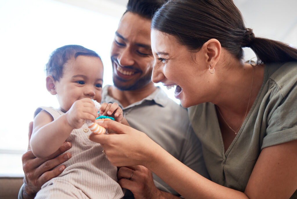 Couple playing with baby at home