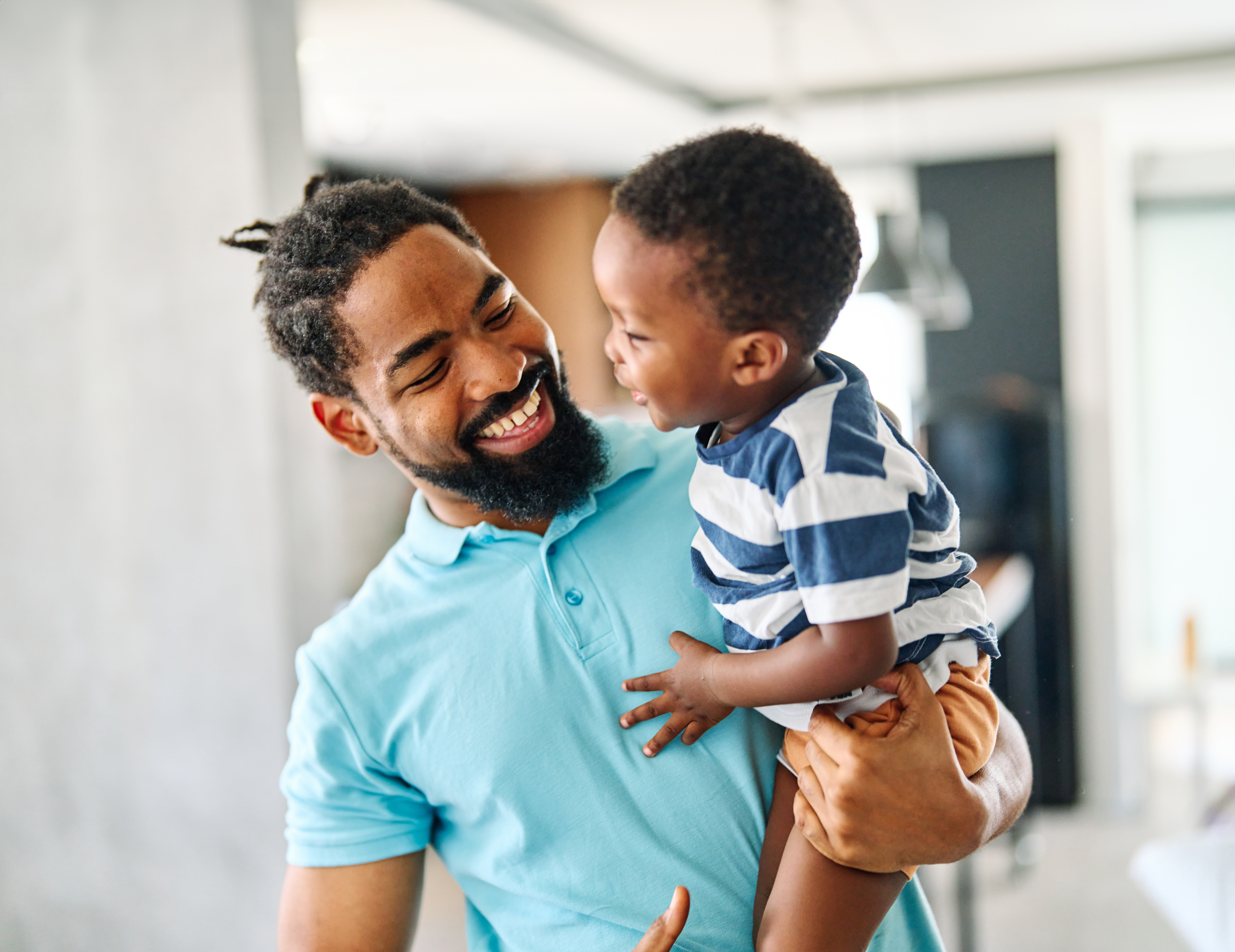 Father and child hugging inside their home