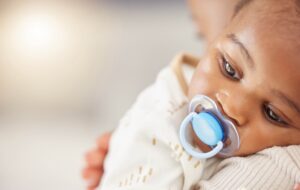 Baby resting on a caregiver's shoulder