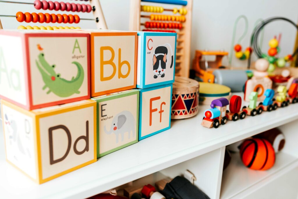 Set of kid toys on a white shelf