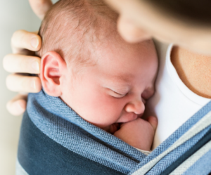 Baby held close to their mother's chest