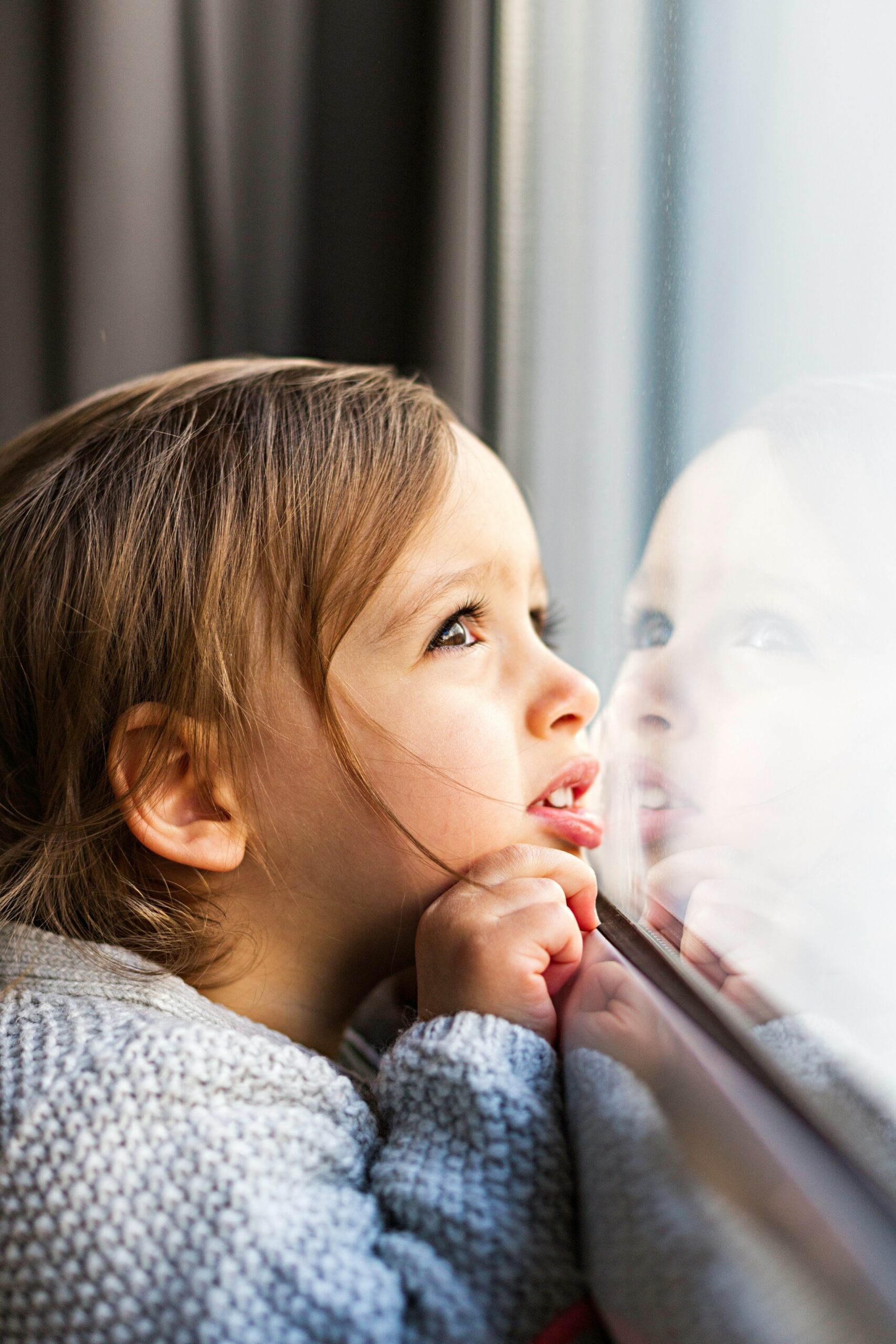 Little girl looking out the window