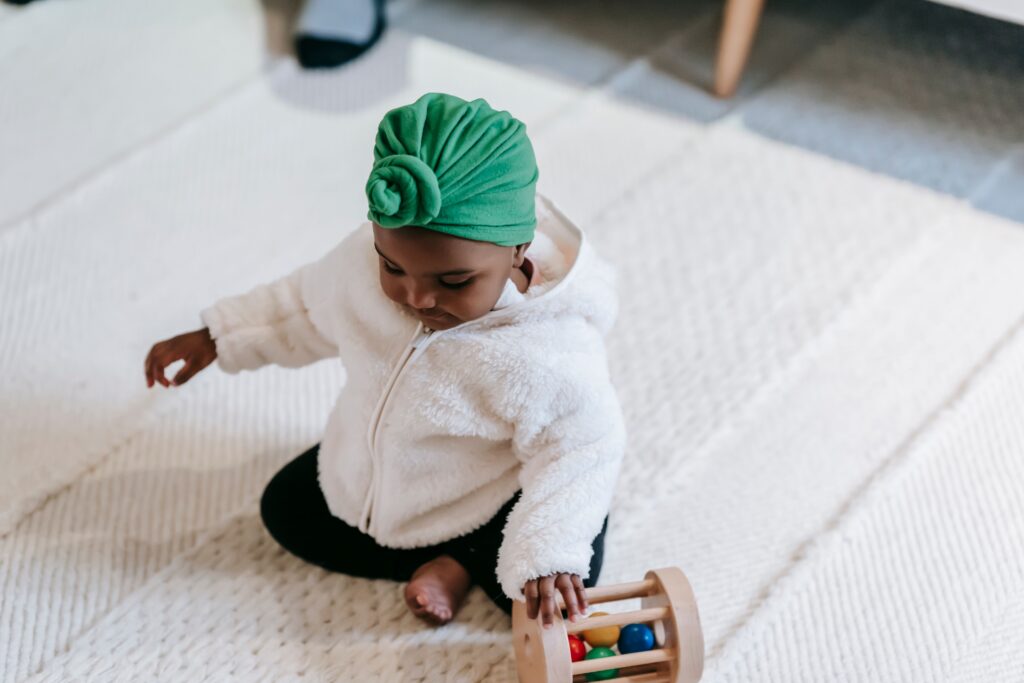 Little girl playing with toys on the floor