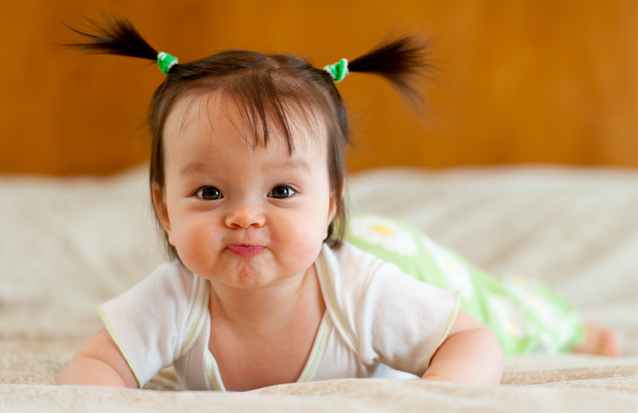 Baby with pig tails smiling