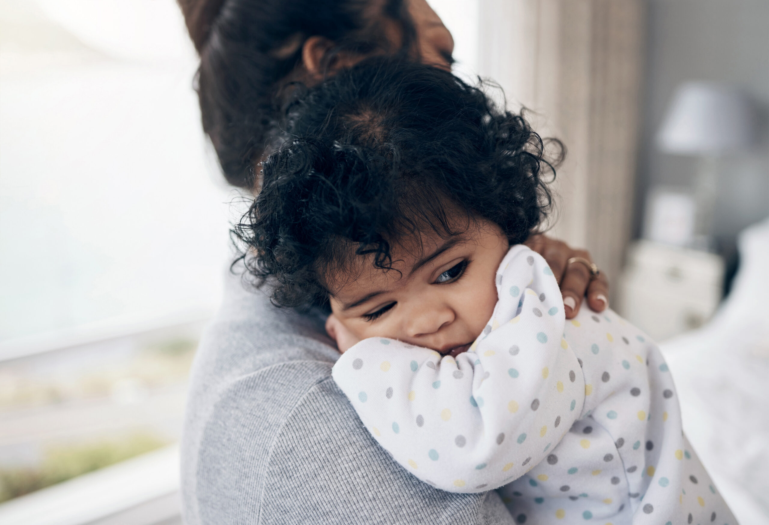 Mama, daughter and bonding with infant in bedroom, holding toddler