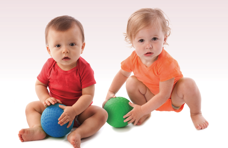 Babies in colorful onesies sitting side by side