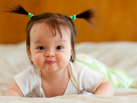 Baby with pig tails smiling