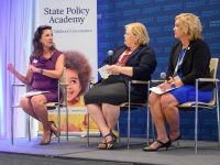 Three individuals participate in a panel discussion at the State Policy Academy, with a backdrop featuring "prenatal-to-3 policy" and a child's image.