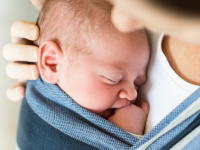 Baby held close to their mother's chest