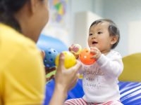 Baby playing with caregiver