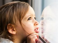 Little girl looking out the window
